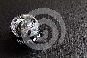 Transparent plastic gyroball on black background