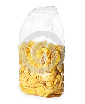 Transparent plastic pack of tasty crispy corn flakes isolated on white