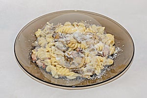 Transparent plate with pasta spaghetti carbonara with cream, mushrooms, bacon