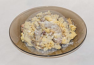 Transparent plate with pasta spaghetti carbonara with cream, mushrooms, bacon