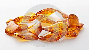 Transparent polished beads of orange amber on a white background. Sun stone. Natural mineral material for jewelry. Amber