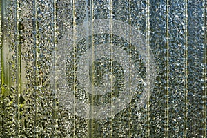 Transparent polycarbonate sheet with morning dew drops. Abstract background