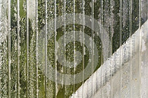 Transparent polycarbonate sheet with morning dew drops. Abstract background