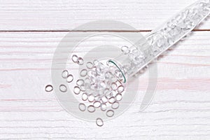 Transparent Polyethylene granules on wooden background.The concept of free bpa. HDPE Plastic pellets. Plastic Raw material .