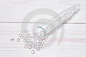 Transparent Polyethylene granules on wooden background.The concept of free bpa. HDPE Plastic pellets. Plastic Raw material .