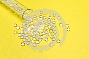 Transparent Polyethylene granules on a yellow background.HDPE Pl