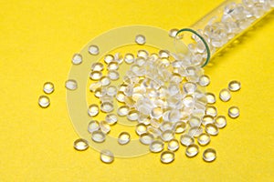 Transparent Polyethylene granules on a yellow background.HDPE Pl