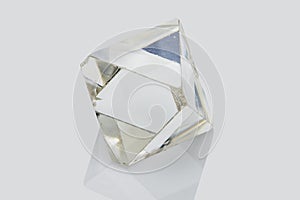 Transparent rough diamond isolated on white background photo