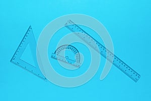 Transparent ruler, triangle protractor on a blue background
