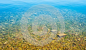 Transparent shallow water with rocky bottom.