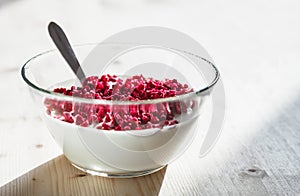 Transparent simple glass bowl filled with plain white yogurt top