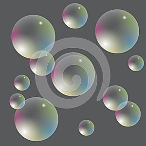 Transparent soap bubbles with iridescent gradient on a gray background.