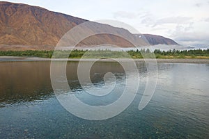 Transparent Sob river in August morning. Polar Ural, Russia photo