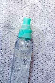 Transparent spray bottle, refillable plastic travel bottle, portable makeup spray bottle on light background