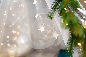 Transparent stars garland on Merry Christmas or New Year background. Warm golden lights and bokeh. Shiny sparkling garlands.