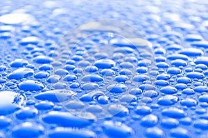 Transparent still water drops on light blue background. Blue water drops. Drops of rain on glass. Blue abstract water drop backgro