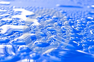 Transparent still water drops on light blue background. Blue water drops. Drops of rain on glass. Blue abstract water drop backgro