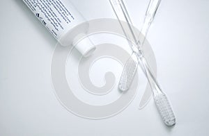transparent sunye brush iwith a tube of white toothpaste on a white background photo