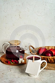 Transparent teapot with red tea with raspberries and apples. Detox antioxidant home health drink. Copy space