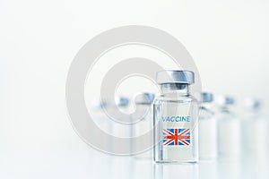 Transparent vials with UK flag. Vaccine for covid-19 coronavirus, flu, infectious diseases. Injection after clinical trials for