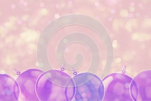 Transparent violet Christmas balls on blurry lights background