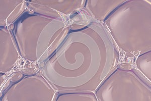 Transparent and voluminous soap bubbles on a blue-silver background