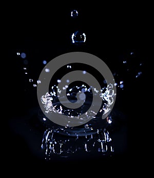 transparent water drop splash realistic and blue water colored on black