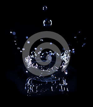 Transparent water drop splash realistic and blue water colored on black