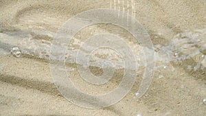Transparent water surface ripples texture motion, waves, splash, sand background
