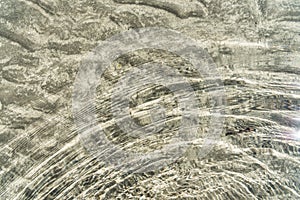 Transparent water surface and sand on the lake bottom.