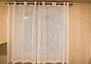 Transparent white curtain at bedroom window in vintage wooden house