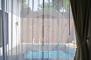 transparent white curtain with swimming pool background for holidays