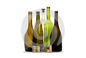 Transparent wine bottle, green wine bottle, brown wine bottles and wine corks on white background