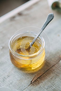 Transparent yellow jam. Natural honey in a glass jar