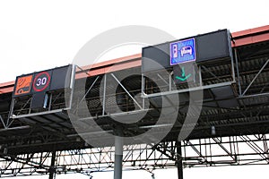Transponder and ticket payment icons on top of toll gates
