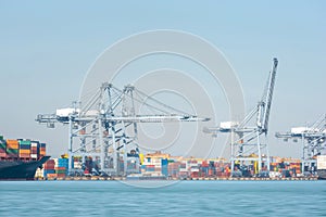 Transport Container Cargo Freight Ship loading and unloading goods containers by harbor crane in shipping port, Logistic Import