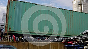 Transport container on a crane. Distribution Warehouse, Cargo Container, Commercial Dock, Junkyard. Slow motion