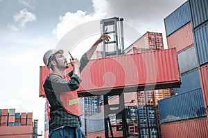 Transport Container Engineer Managing Control Via Walkie Talkie in Containers Shipyard. Container Logistics Shipping Management of