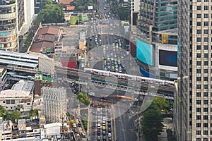 Transport on the crossroad in Bangkok at rush hour. Traffic of vehicles - cars, bikes and train on highway