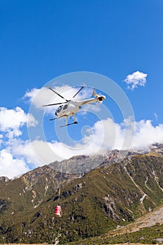 Transport helicopter fly over mountain wilderness
