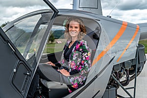 transport by helicopter. A young woman in a helicopter travels to a buseness meeting