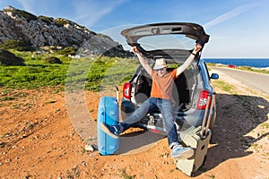 Transport, leisure, road trip and people concept - happy man enjoying road trip and summer vacation.