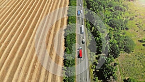 Transport logistic background. Trucks and cars on a highway.