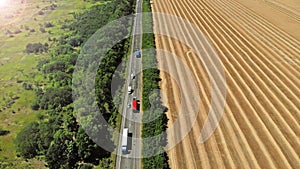 Transport logistic background. Trucks and cars on a highway.