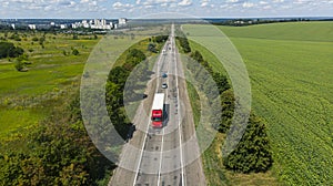 Transport logistics background. Commercial truck and cars driving by the highway. View above