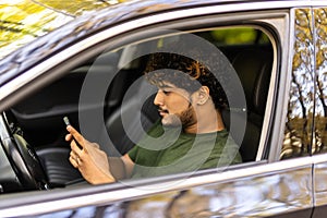 transport, people and technology concept - smiling indian man or driver using phone in car