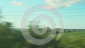 Transport, travel, road, railway, landscape, communication concept - view from the window of speed train on landscape of