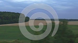 Transport, travel, road, railway, landscape, comnication concept - view from window of speed train on landscape of