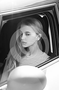 Transport and travelling. Pretty girl with pensive face looking through car window