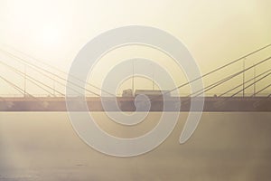 Transport truck on a highway with fog and sunrise